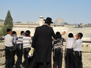 A group of ultra-Orthodox Jews in the Jewish Quarter of Jerusalem's Old City look out onto the Al-Aqsa Mosque on September 13, 2012. RNS photo by Neri Zilber