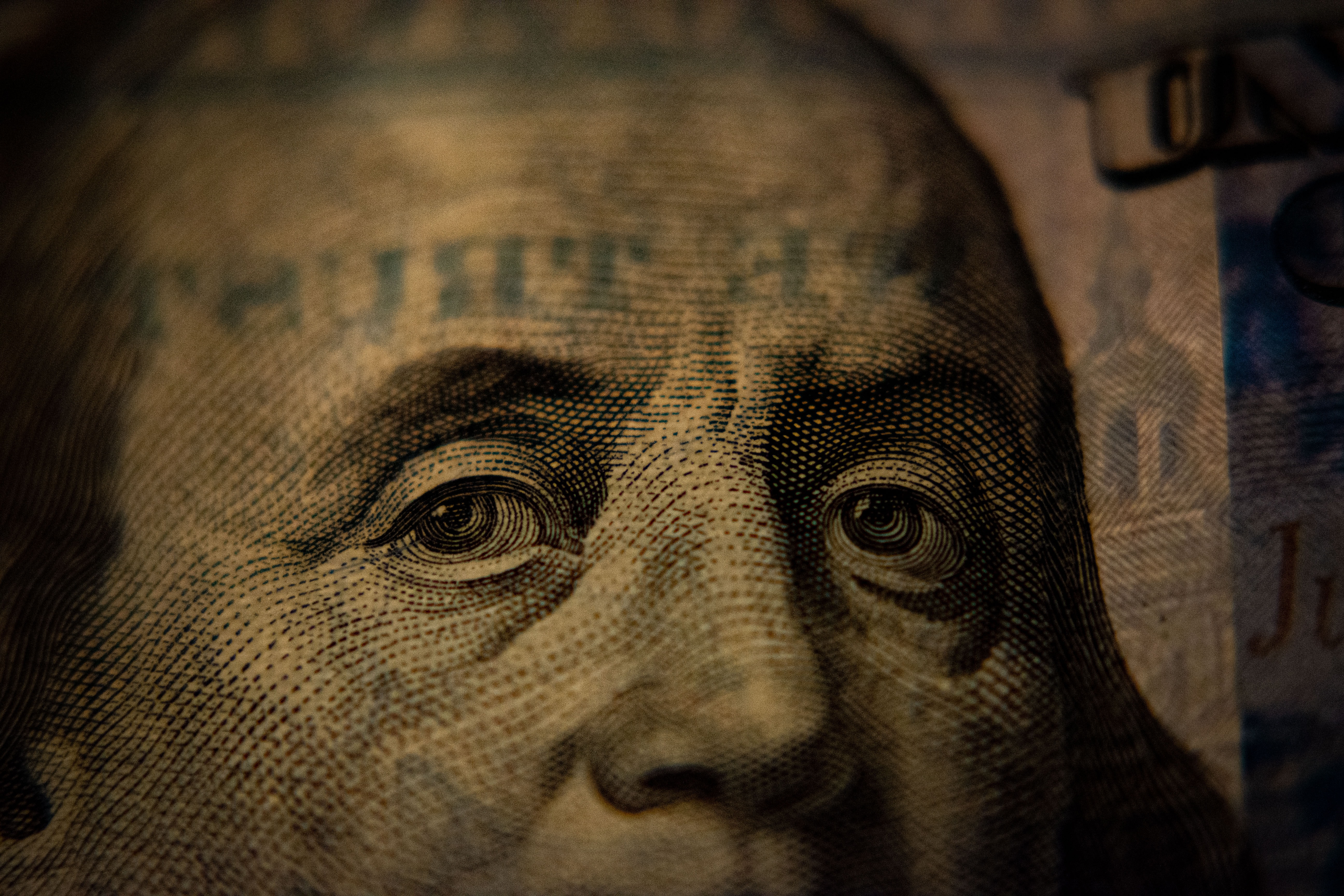 A closeup of a US hundred dollar bill (Benjamin Franklin side).