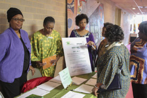 Rosalyn Priester, Pat Owens and Adrienne Wynn stand at the Earth Day display encouraging members at Trinity United Church of Christ to shrink their carbon footprint. RNS photo courtesy of Trinity UCC Photography Ministry